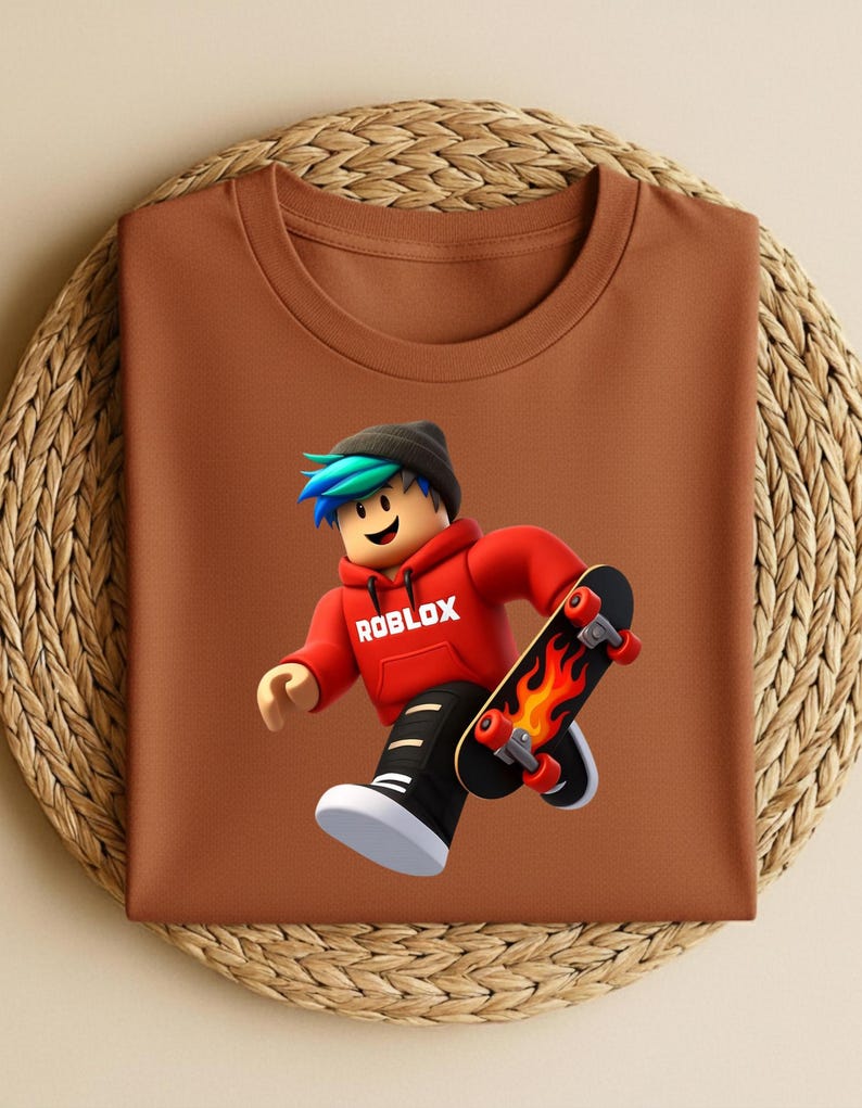 May include: A brown t-shirt featuring a Roblox character with blue and green hair, wearing a red hoodie with the Roblox logo, black pants, and white shoes. The character is holding a skateboard with a flame design.