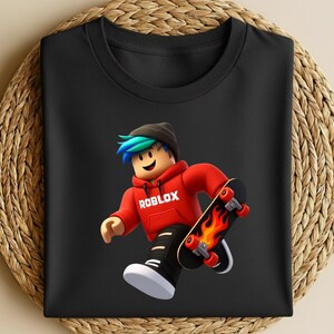 May include: Black t-shirt featuring a cartoon character in a red hoodie with the word "ROBLOX" and a skateboard with flames. The character has blue and green hair and is wearing a black beanie.