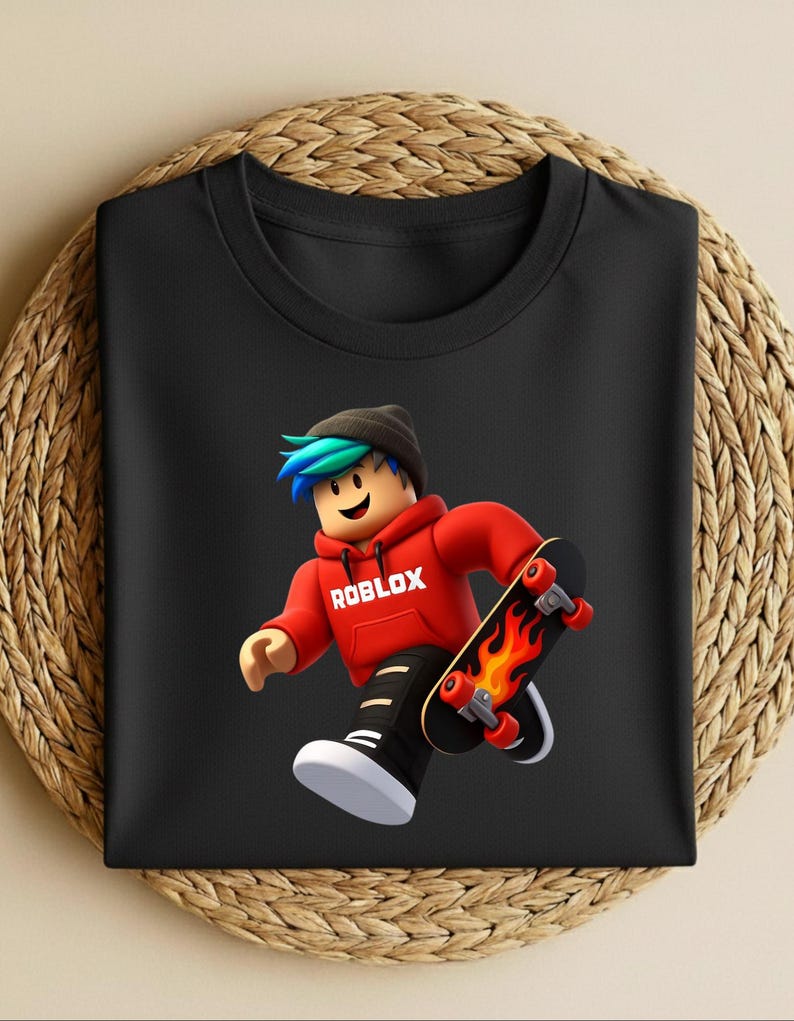 May include: Black t-shirt featuring a cartoon character in a red hoodie with the word "ROBLOX" and a skateboard with flames. The character has blue and green hair and is wearing a black beanie.
