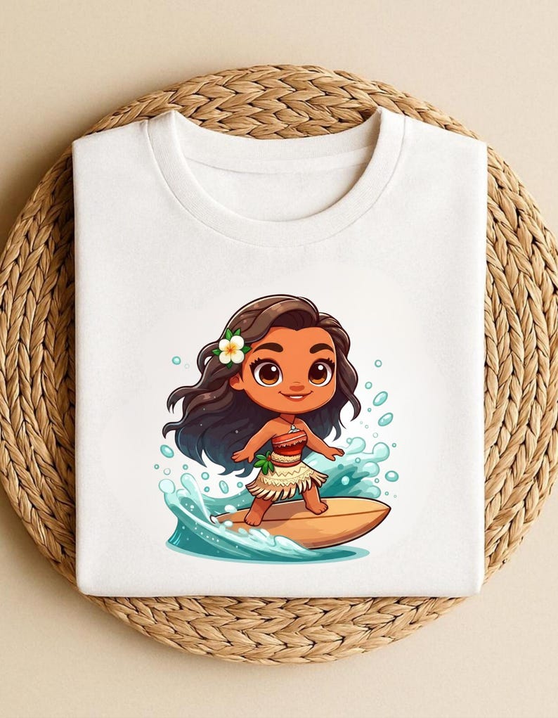 May include: White crew neck t-shirt featuring a cartoon illustration of a girl surfing. The girl has brown hair, a flower, and is wearing a skirt. The design includes blue water and a surfboard.
