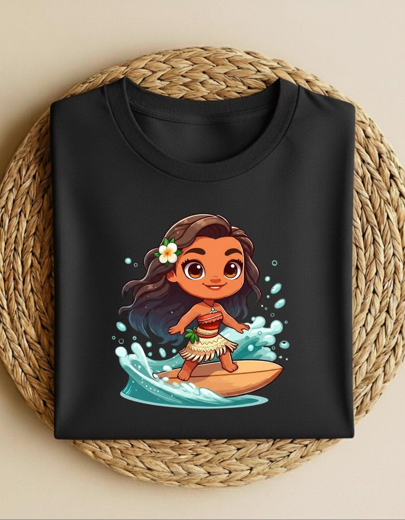 May include: Black crew neck t-shirt featuring a cartoon illustration of a girl surfing on a surfboard. The girl has brown hair, a flower, and is wearing a skirt. The surfboard is light brown, and the waves are blue and white.