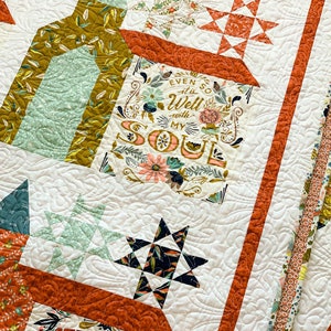 May include: A white quilt with a patchwork design featuring various floral patterns, stars, and text. The text includes "Even so it is well with my soul" and "Strength for today and bright hope for tomorrow".