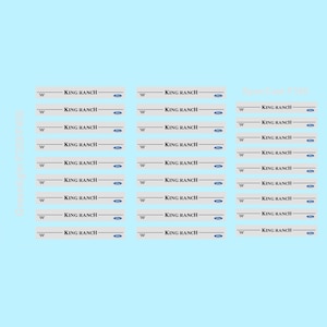 May include: Multiple stickers with the text "KING RANCH" in black, with a blue Ford logo. The stickers are on a light gray background with a light blue background.