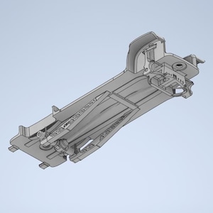 Puede incluir: Modelo 3D detallado en escala de grises de un componente de vehículo, posiblemente un elemento aerodinámico. El diseño presenta estructuras internas complejas, incluyendo muelles y piezas mecánicas. El componente tiene una forma aerodinámica con superficies anguladas y detalles intrincados.