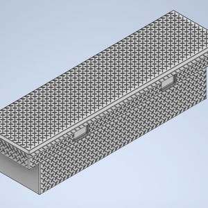 May include: A gray metal truck tool box with a diamond plate pattern on the top and sides. The box has two rectangular openings on the side and sits on a light gray surface.