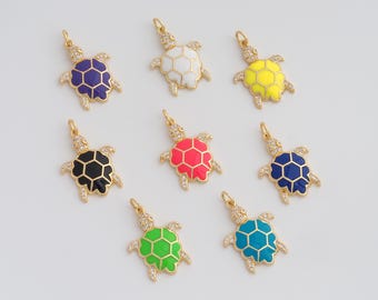 May include: Gold-toned turtle charms with colorful enamel shells. The charms feature a variety of colors, including purple, white, yellow, black, pink, blue, green, and turquoise. Each charm has a gold loop for attaching to a necklace or bracelet.