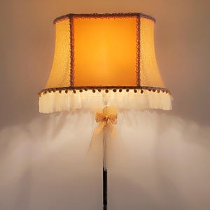 Floor lamp with pink textile shade to create a warm and cozy corner