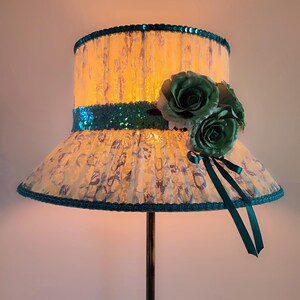 A floor lamp with a milky turquoise shade in the form of a hat for an original interior.