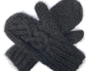 May include: A pair of dark charcoal gray knitted mittens featuring a textured cable knit pattern on the back of the hand and a ribbed cuff. The mittens are crafted from a fuzzy, soft-textured yarn with a distinct thumb section.