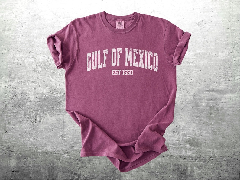 May include: A maroon t-shirt with a white graphic that says "Gulf of Mexico Est 1550".