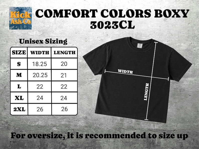 Puede incluir: Una camiseta negra de manga corta etiquetada como Comfort Colors Boxy 3023CL. Una tabla de tallas muestra las medidas de ancho y largo en pulgadas para las tallas S a 2XL, con l&iacute;neas blancas en la camiseta indicando d&oacute;nde se mide el ancho y largo.