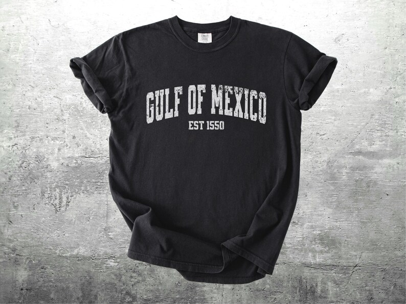 May include: Black t-shirt with white text that reads "GULF OF MEXICO EST 1550".