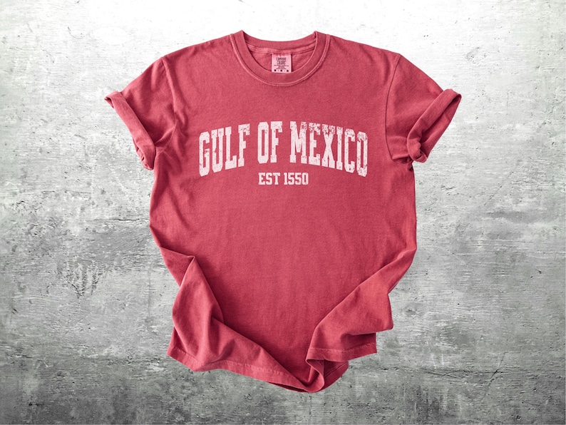 May include: Red t-shirt with white text that reads "GULF OF MEXICO EST 1550".