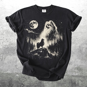 May include: Black t-shirt featuring a detailed graphic of a Pomeranian dog howling at the moon. The design includes a full moon, trees, and stars, creating a night scene. The shirt is made of a soft material.