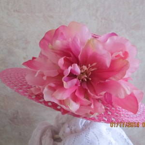 May include: A pink sun hat with a large, vibrant pink flower. The hat has a woven design with small holes. The flower is a layered design with a light pink center. The date "01/17/2014 03:45" is printed on the hat.