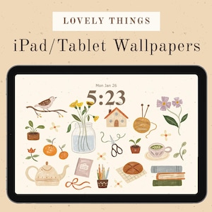 May include: An iPad or tablet screen shows a wallpaper with the text "LOVELY THINGS" and "iPad/Tablet Wallpapers." The design includes illustrations of a bird, flowers, a house, yarn, a teapot, and other decorative elements.