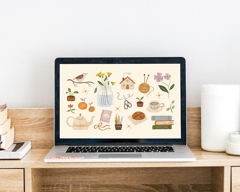 May include: A laptop computer screen displaying a digital illustration of various objects, including a teapot, a house, a bird, flowers, books, and a cup of tea. The background is a light beige color.
