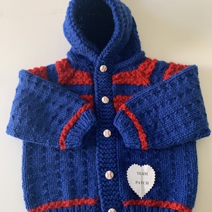 May include: Blue knitted hooded cardigan with red stripes and baseball buttons. The cardigan has a heart-shaped patch that says "TEAM PATCH".