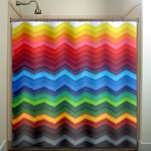 May include: A colourful shower curtain with a chevron pattern in shades of yellow, orange, red, pink, purple, blue, green, brown, and grey.
