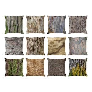 May include: Twelve decorative throw pillows with different bark and wood textures. The pillows are all square and have a light brown background.