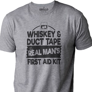 May include: Gray t-shirt with a black graphic that says "Whiskey & Duct Tape the Real Man's First Aid Kit".