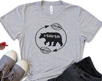 May include: Gray t-shirt with a black bear silhouette and the word "mama" inside a circle with arrows and leaves.
