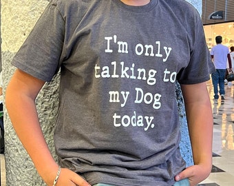 May include: A dark gray t-shirt with white text that reads "I'm only talking to my Dog today."
