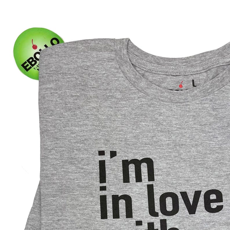 May include: Gray t-shirt with the text "i'm in love with the" printed on the front.