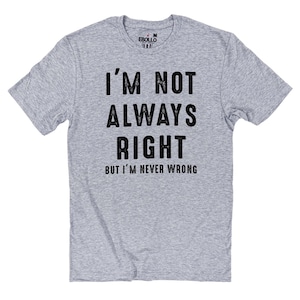 May include: A light gray t-shirt with the text "I'M NOT ALWAYS RIGHT BUT I'M NEVER WRONG" in black. The shirt has short sleeves and a crew neck. The brand name "EBOLLO" is printed on the upper back of the shirt.