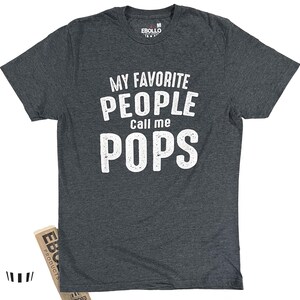 May include: A dark gray t-shirt with the text "My Favorite People Call Me Pops" in white lettering.