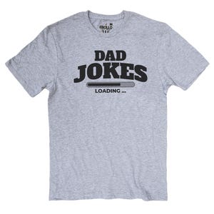 May include: A light gray t-shirt with the words "DAD JOKES" in bold black letters. Below the text is a loading bar graphic, and the word "LOADING..." is printed below the bar. The shirt has a crew neck and short sleeves.