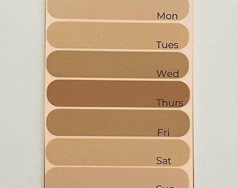 May include: A beige and brown color chart with the days of the week labeled: Mon, Tues, Wed, Thurs, Fri, Sat, Sun.