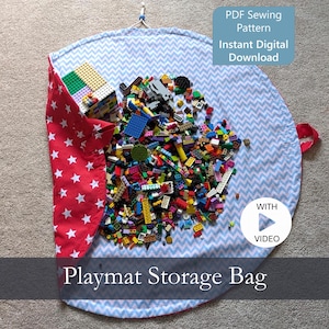 May include: A circular fabric playmat storage bag featuring a light blue and white chevron pattern on the interior and a red fabric with white stars on the exterior. The bag is filled with colorful plastic building blocks and includes a drawstring closure. Text reads: PDF Sewing Pattern Instant Digital Download, WITH VIDEO, Playmat Storage Bag.