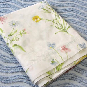 May include: A set of three ceramic mugs with a speckled, matte finish. The mugs are in shades of cream, light gray, and dark gray. Each mug has a simple, minimalist design and a rounded handle. The mugs are stacked on top of each other.