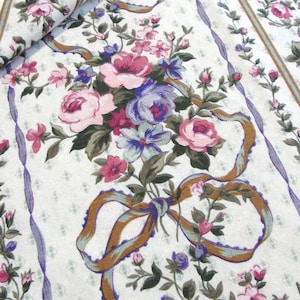 May include: Fabric featuring a floral design with pink, purple, and blue blooms. Bouquets of flowers are tied with brown ribbons and green foliage. The white background has a subtle diamond pattern, with vertical stripes.