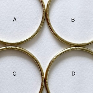 May include: Four gold-coloured metal hoops with a hammered texture. The hoops are labelled A, B, C, and D.