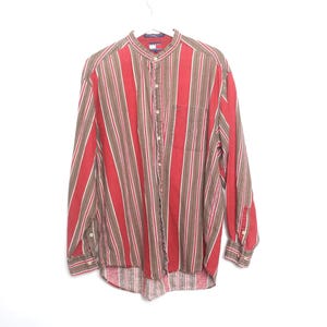 May include: A long-sleeved button-up shirt with a mandarin collar. The shirt is striped in red, brown, and white.