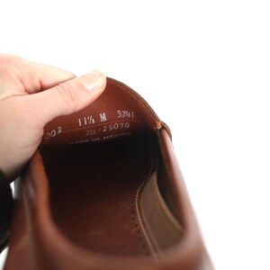 May include: Close-up of the inside of a brown leather shoe with the size 11 1/2 M, 20-25070, 3241, and Made in Mexico printed on the insole.