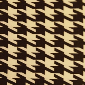 May include: Black and white houndstooth pattern fabric. The pattern is a classic design with a repeating motif of black and white squares.