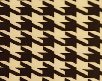 May include: Black and white houndstooth pattern fabric. The pattern is a classic design with a repeating motif of black and white squares.