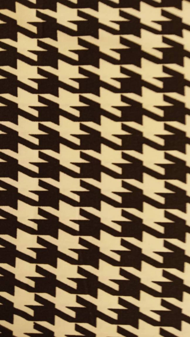 May include: Black and white houndstooth pattern fabric. The pattern is a classic design with a repeating motif of black and white squares.