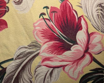 May include: Close-up of a floral pattern featuring large, stylized flowers in shades of pink and burgundy against a yellow background. The design includes gray and white leaf-like elements, creating a vintage, botanical theme.