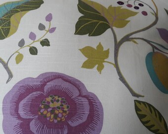 May include: A white fabric with a floral pattern. The pattern features a large purple flower with a yellow centre, green leaves, and small purple berries.