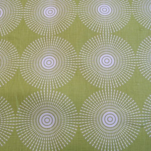 May include: Green fabric with a white repeating pattern of concentric circles with radiating lines. The circles have a white outline.
