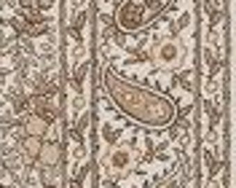 May include: Cream-colored fabric with a repeating paisley and floral pattern in shades of brown and tan. Vertical stripes frame the design, creating a textured and detailed textile.