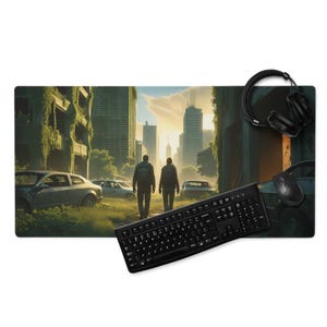 May include: A rectangular mousepad featuring a post-apocalyptic cityscape with two figures walking away from the viewer. A black keyboard, mouse, and headphones are placed on the mousepad. The image shows a destroyed city with overgrown vegetation.
