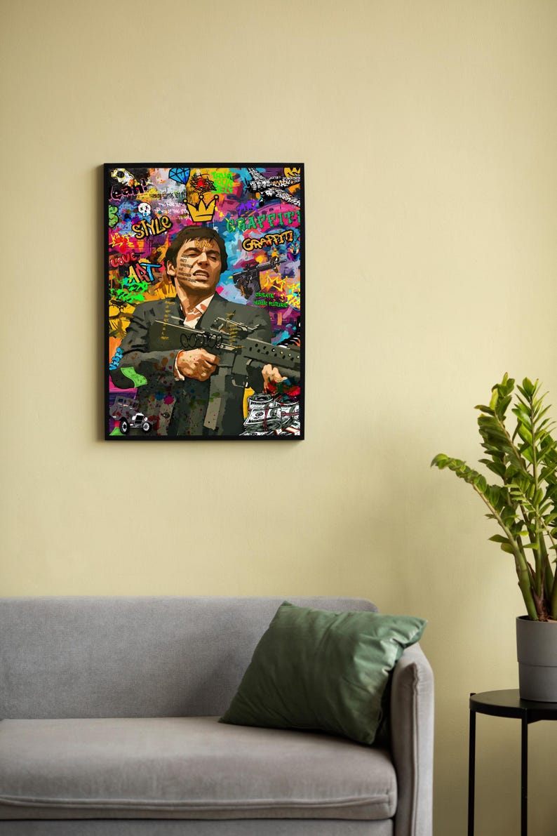 May include: A colorful, abstract painting of a man holding a gun. The painting is framed in black and features graffiti-style text, including "Smile", "Art", and "Happy Graffiti".