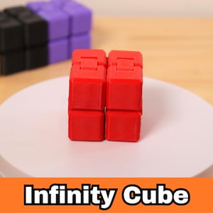 May include: A red Infinity Cube is displayed on a white platform, with other colorful cubes in the background. The cube is made of eight connected blocks that can be manipulated. The text "Infinity Cube" is displayed in a banner below.