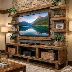May include: A rustic entertainment center with a large flat-screen TV mounted on a stone wall. The wooden unit features shelves, storage baskets, and decorative plants, creating a warm, inviting living space.