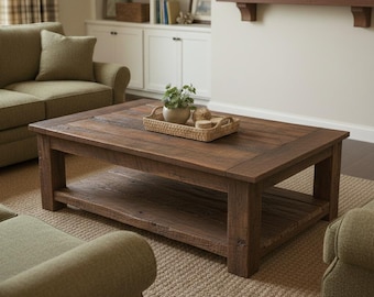 May include: A rectangular coffee table constructed from dark brown wood with a smooth top surface and a lower shelf for storage. The table features four thick, sturdy legs and a natural wood grain finish, supporting a woven tray with a small plant.